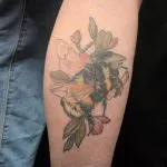 A photo of the illustrative tattoo of a bumble bee, after one treatment, 9 weeks later