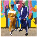 A photo of Ben Alway and Madi Rawson in front of the mural by Jean Paul Langlois