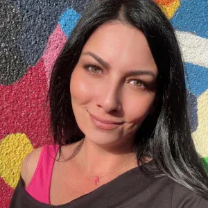 A photo of Heidi Freschauf in front of the mural by Jean Paul Langlois