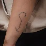 A photo of a constellation tattoo on the forearm, before any laser tattoo removal treatments.