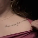 A photo of the collarbone script after 1 laser tattoo removal treatment, 8 weeks later.