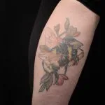 A photo of the illustrative tattoo of a bumble bee, after one treatment, 17 weeks later