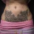 A photo of a Blackwork and illustrative tattoo on the Belly on a person with FitzPatrick Skin Type iv type 1 11 Weeks after their  treatment. This client is hoping for Cover Up Tattoo