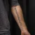 A photo of a Blackwork, illustrative and Script 17 Years old tattoo on the Belly and forearm on a person with FitzPatrick Skin Type iii and iv type 1. This client is hoping for Complete Removal