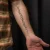 A photo of a Blackwork and Script 17 Years old tattoo on the forearm on a person with FitzPatrick Skin Type iii 14 Weeks after their  treatment. This client is hoping for Complete Removal