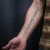 A photo of a Blackwork and Script 17 Years old tattoo on the forearm on a person with FitzPatrick Skin Type iii 14 Weeks after their  treatment. This client is hoping for Complete Removal