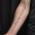 A photo of a Blackwork, illustrative and Script 17 Years old tattoo on the Belly and forearm on a person with FitzPatrick Skin Type iii and iv type 1 12 Weeks after their  treatment. This client is hoping for Complete Removal